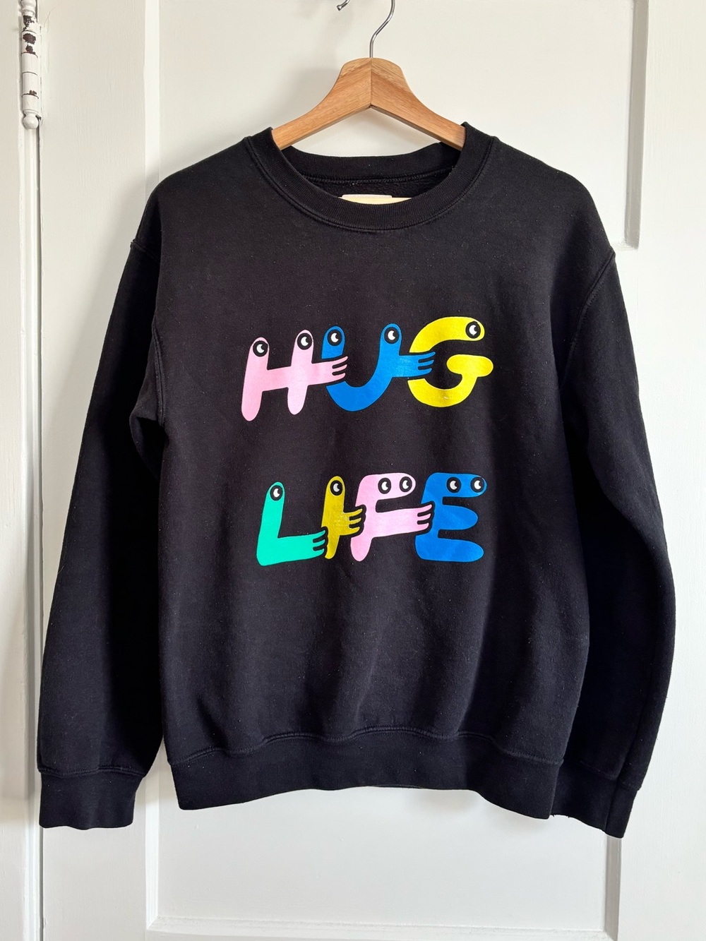 Feelings by Pony - Artist Graphic Crewneck Sweater - “hug life” in Black
